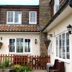 White upvc windows on a cream traditional house