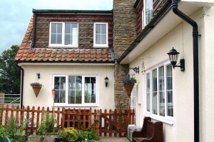 White upvc windows on a cream traditional house