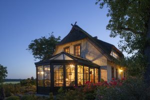 Conservatory lit up at dusk