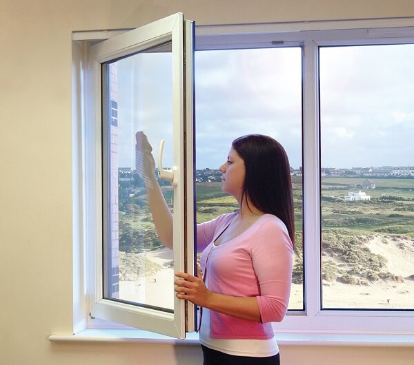 woman cleaning open window