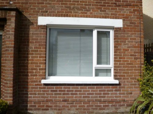 Large white window with different size glazing panels