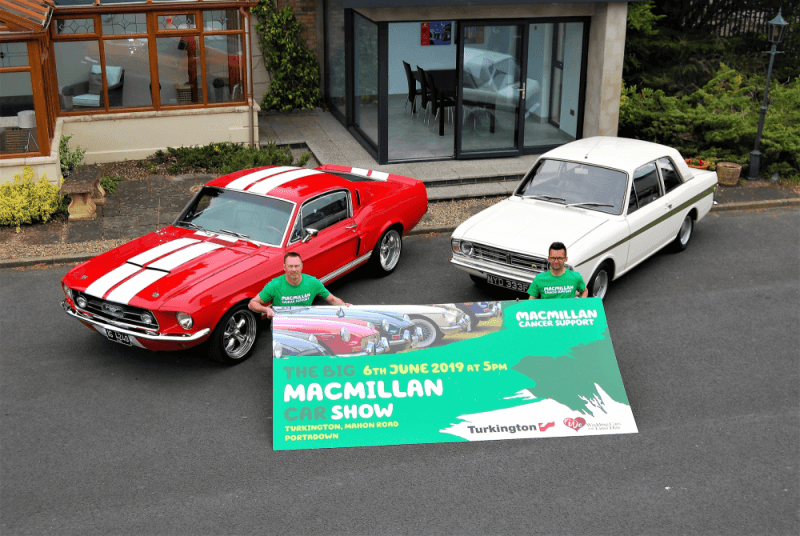 Aerial view of red and white car with Macmillan show banner