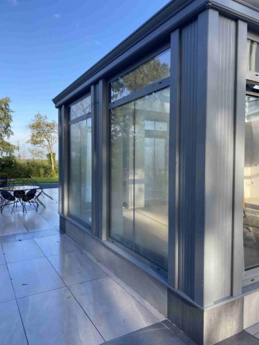 the outside of an aluminium bespoke grey conservatory installed by Turkington windows