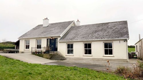 zoomed out view of house featuring white upvc sash windows