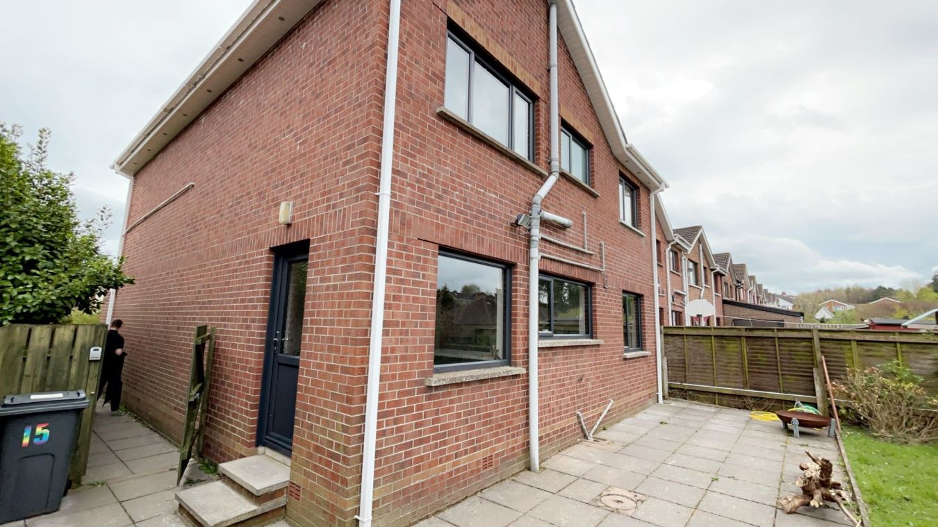 installation of grey windows on a brick house
