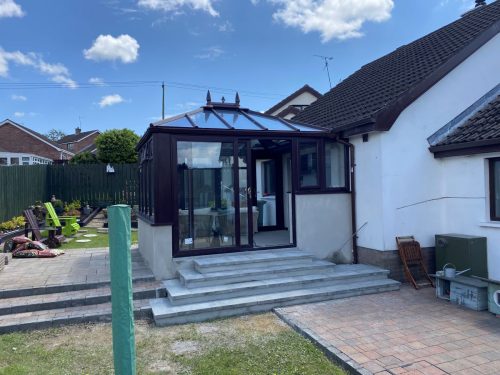 glass roof conservatory installation with sliding patio doors